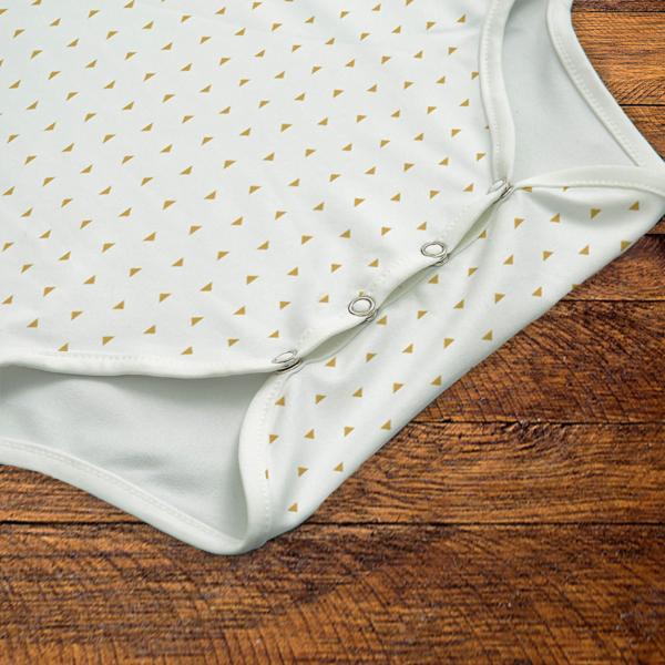Gold Triangles White Onesie Snaps Closeup Mockup V1