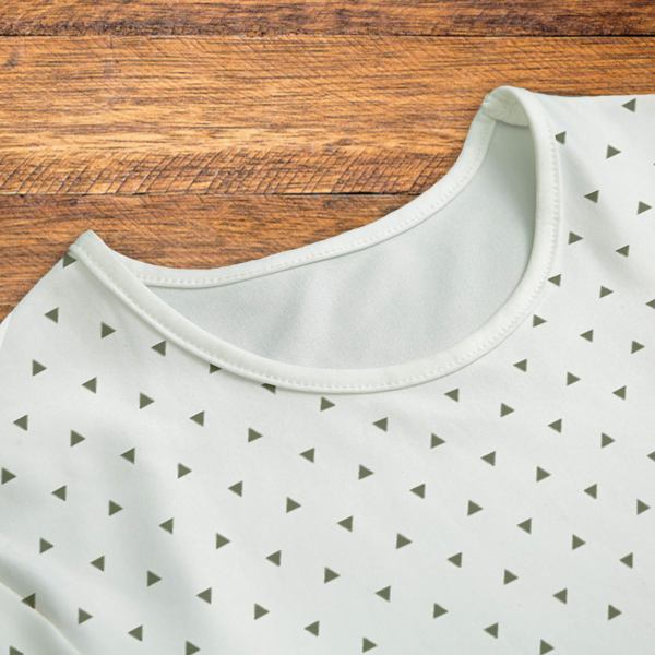 Green Triangles White Onesie Closeup Mockup V1